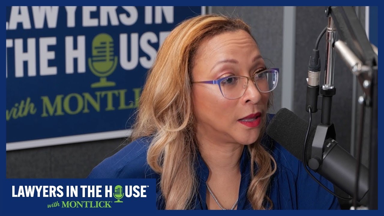 Blonde woman in glasses speaking into microphone with "Lawyers in the House with Montlick" logo behind her