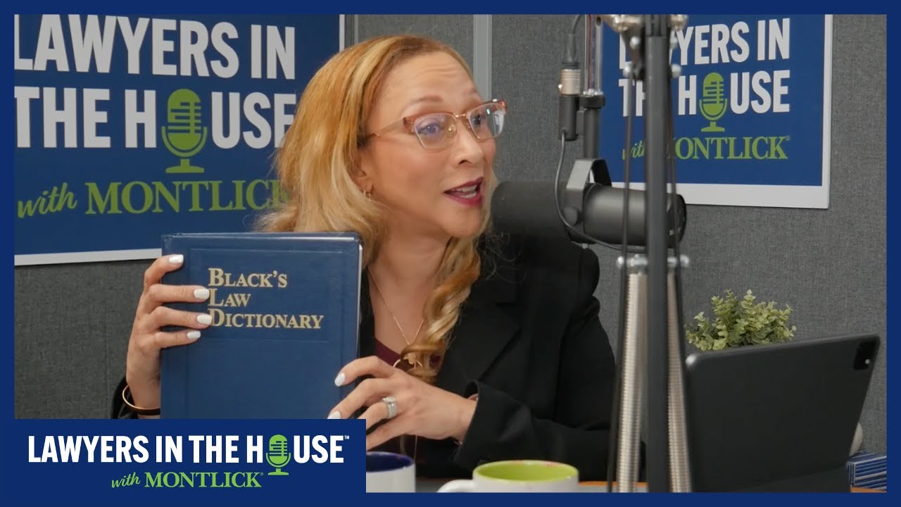 Blonde woman lawyer holding Black's Law Dictionary book during Lawyers in the House podcast recording